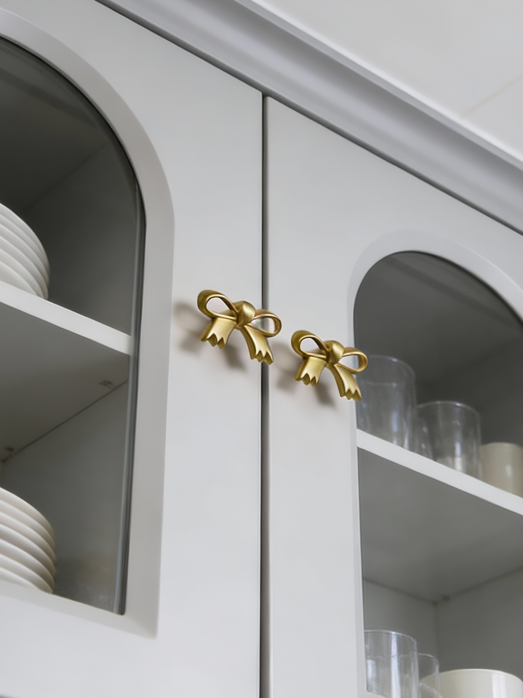 Bow brass cabinet pull installed view
